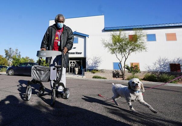 Man with walker and small dog