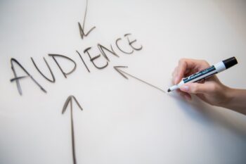 Arrows pointing to the word "audience" written on a whiteboard